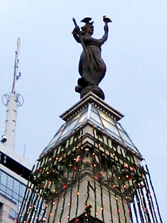 The top of the statue (tree) with birds on its head.